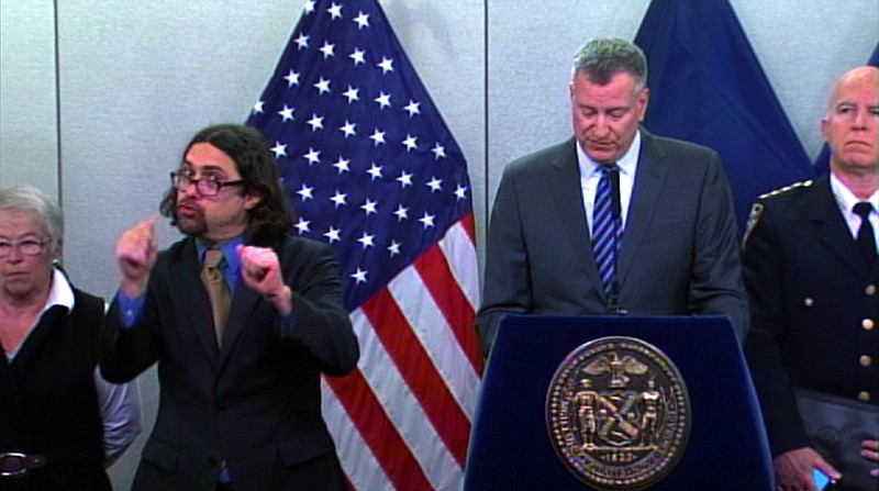 
              In this Monday Jan. 26, 2015 video frame grab released by New York City Office of The Mayor, Sign-language Interpreter Jonathan Lamberton, left, translates during a news conference by New York City Mayor Bill de Blasio (AP Photo/ New York City Office of The Mayor)
            