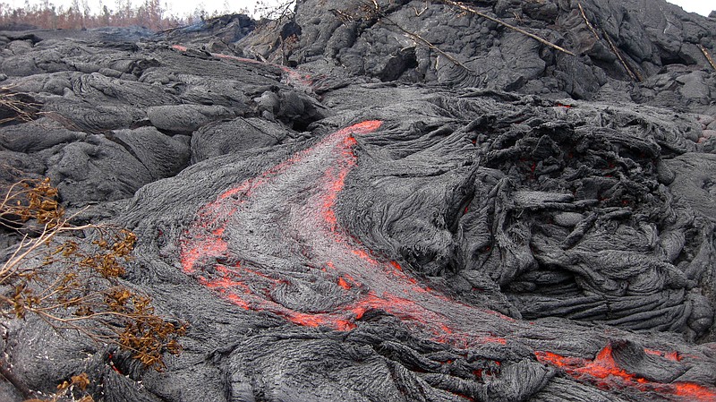 This Jan. 26, 2015, photo released by the U.S. Geological Survey shows one of many small breakouts of lava on the surface of the June 27 flow immediately upslope of the leading edge near the town of Pahoa on the Big Island of Hawaii. 