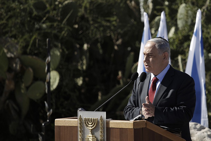 
              Israeli Prime Minister Benjamin Netanyahu speaks during the memorial ceremony of former Israeli Prime Minister Ariel Sharon, on the 1st anniversary of his death at his grave site, in Havat Shikmim southern Israel, Thursday, Jan. 29, 2015.(AP Photo/Tsafrir Abayov)
            