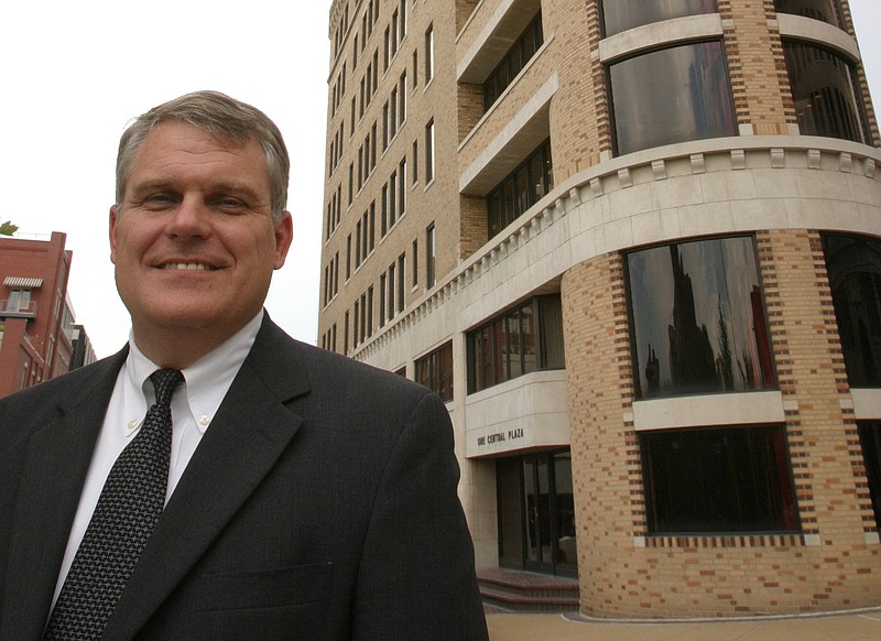 Cornerstone Bank CEO Frank Hughes stands in front of the One Central Plaza building.