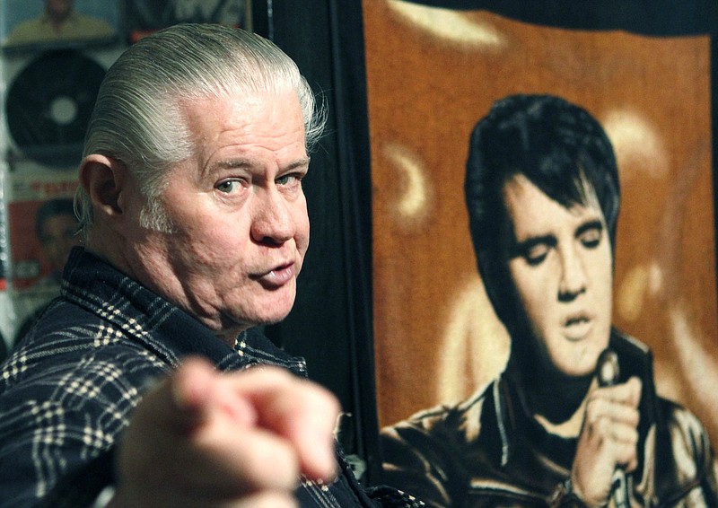 
              FILE - This Dec. 9, 2009 file photograph shows the late Paul MacLeod, an Elvis fanatic at the antebellum home he calls "Graceland Too," in Holly Springs, Miss., near a blanket bearing a portrait of his idol. He died July 17, 2014. MacLeod's two-story home and its Elvis-centric contents are to be auctioned Saturday, Jan. 31, 2015. (AP Photo/Rogelio V. Solis)
            