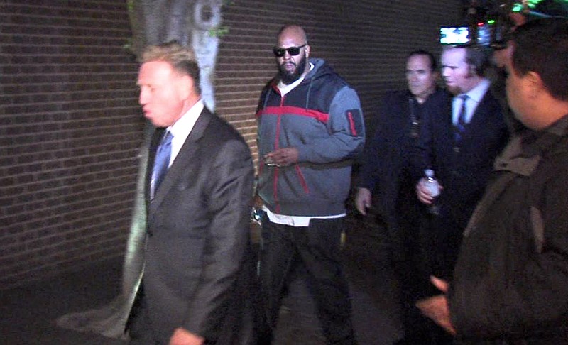 This image from video shows Death Row Records founder Marion "Suge" Knight, right, walking into the Los Angeles County Sheriffs department early Friday morning Jan. 30, 2015, in connection with a hit-and-run incident that left one man dead and another injured.
