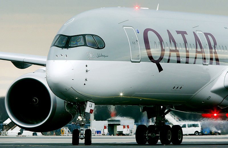 
              FILE- In this Jan. 15, 2015 file photo, the new Airbus A 350 of Qatar Airways coming from Doha, Qatar, approaches the gate at the airport in Frankfurt, Germany. Qatar Airways announced Friday, Jan. 30, 2015, that it has bought nearly 10 percent of the parent company of British Airways and Spain's Iberia, deepening wealthy Qatar's business ties to Europe and intensifying competition with the airline's fast-growing Gulf rivals. (AP Photo/Michael Probst-file)
            