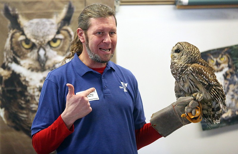 Mike Havlik, head naturalist with Des Moines Y-Camp, displays a barred owl while giving a presentation to a fourth-grade class at Hoover Elementary School on Jan. 15, 2015, in Dubuque, Iowa.