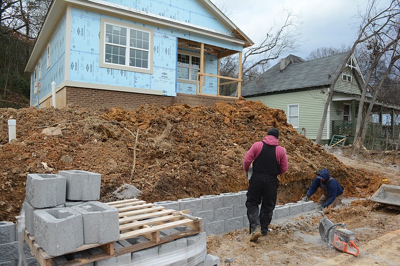 Jason Grap, left, and Jason Heard of Hedgecoth Construction build a wall in front of one of two new Habitat houses being built on Snow Street in North Chattanooga on Jan. 7, 2015, 