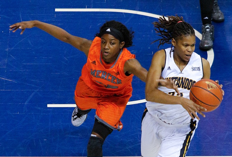 UTC guard Moses Johnson, right, rebounds the ball ahead of Mercer forward Alex Williams during the Mocs' SoCon basketball game against the Bears on Saturday, Jan. 31, 2015, at McKenzie Arena.