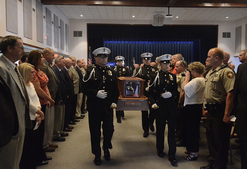 Honor guard members carry Tanja's remains from the building after a memorial service for the Walker County K-9 deputy at the Walker County Civic Center in this June 20, 2014, photo.