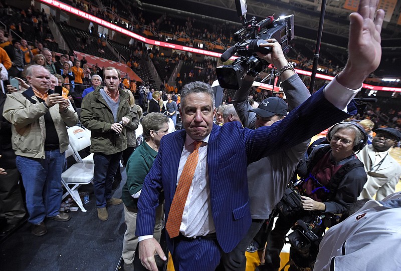 Auburn head coach Bruce Pearl waves goodbye to supportive fans while leaving the court following Auburn's 71-63 loss to Tennessee in an their game at Thompson-Boling Arena in Knoxville on Saturday, Jan. 31, 2015. 
