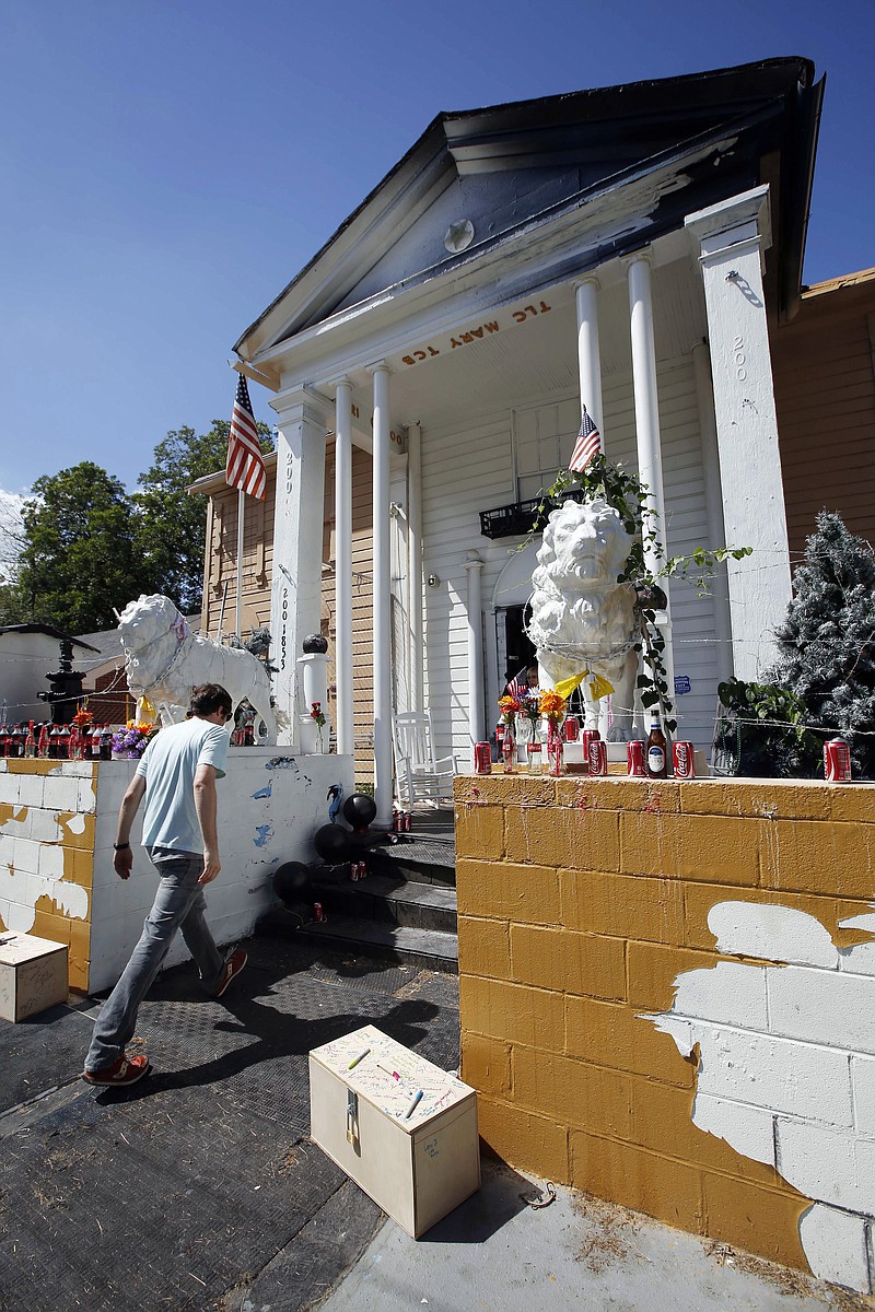 
              FILE - In this Aug. 12, 2014, file photo, a visitor walks up the front steps of Graceland Too, an offbeat museum in Holly Springs, Miss., dedicated to Elvis Presley and owned by the late Paul MacLeod, an Elvis-obsessed man. The contents and house will be auctioned Saturday, Jan. 31, 2015. MacLeod died last summer. (AP Photo/Rogelio V. Solis, File)
            