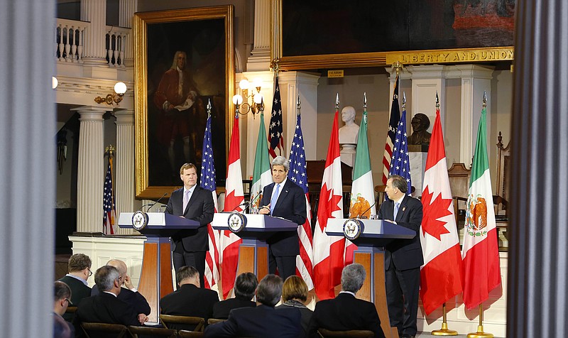 
              U.S. Secretary of State John Kerry, center, speaks at a news conference with Canadian Foreign Minister John Baird, left, and Mexican Foreign Secretary Jose Antonio Meade at Faneuil Hall in Boston Saturday, Jan. 31, 2015. (AP Photo/Winslow Townson)
            