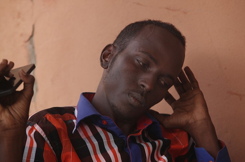 
              In this photo taken Thursday, Jan. 29, 2015, Somalian, Salat Abdullahi, talks with the Associated Press, in what is known as Little Mogadishu in Johannesburg. Abdullahi is living in temporary quarters after he was barricaded inside the shop that he worked and slept in, in Soweto, while looters threatened him from outside during unrest and looting in the township south west of Johannesburg. (AP Photo/Denis Farrell)
            