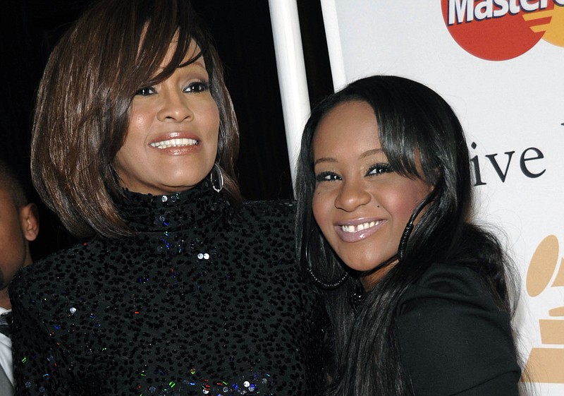 Whitney Houston, left, and daughter Bobbi Kristina Brown arrive at an event in Beverly Hills, Calif., in this 2011 file photo.  The daughter of late singer and entertainer Whitney Houston was found Saturday, Jan. 31, 2015, unresponsive in a bathtub by her husband and a friend and taken to an Atlanta-area hospital. The incident remains under investigation. 