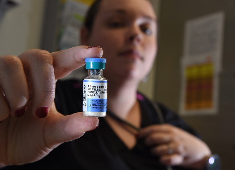 Shelly Donahoe, RN, nurse manager for Adult Immunization and Travel Clinic at the Hamilton County Health Department, holds a vile of the M-M-R (Measles, Mumps and Rubella) vaccine.