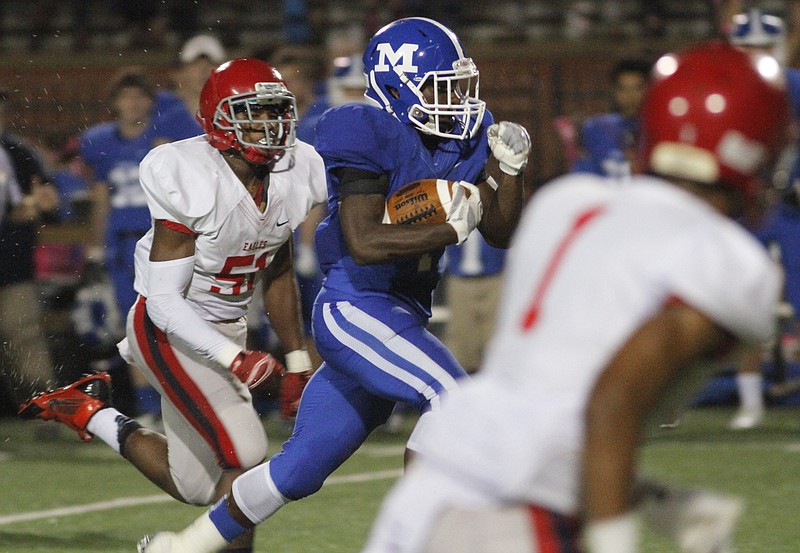 McCallie School's Alex Trotter (4) outsprints Brentwood Academy defenders to score a touchdown during their game on Oct. 10, 2014. 