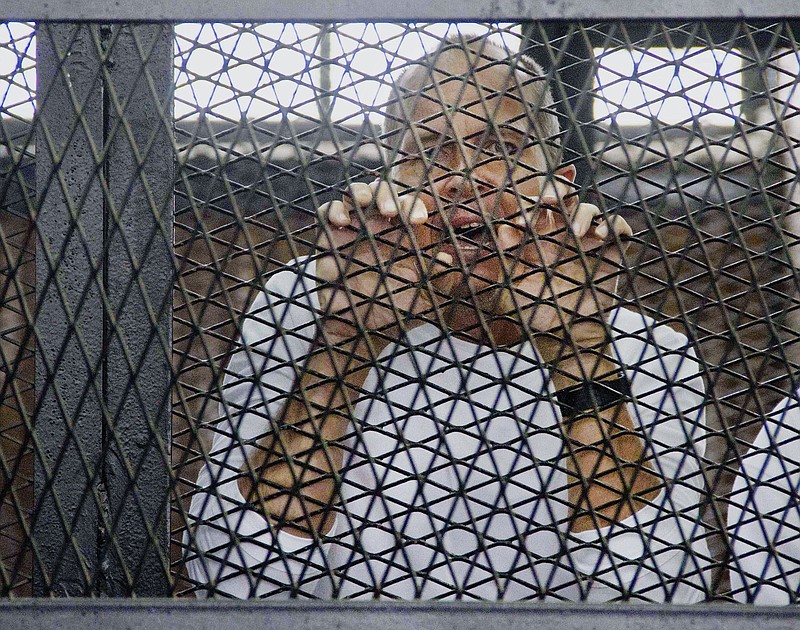 Al-Jazeera's award-winning Australian correspondent Peter Greste, appears in a defendants' cage in a courthouse near Tora prison in Cairo, Egypt, in this May 3, 2014 file photo.