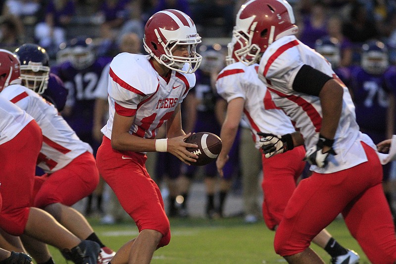 Whitwell High School quarterback Tyler Tate (10) looks to hand off the ball while playing against Marion County High School at Bill Baxter stadium in Jasper, Tenn.