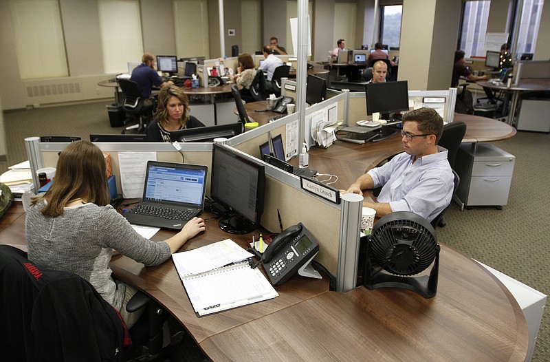 Employees work in the Client Services devision of TractManager in downtown Chattanooga's Suntrust building.