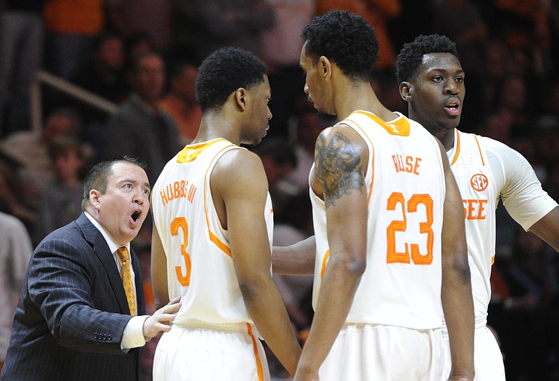 Tennessee head coach Donnie Tyndall, left, encourages guards Robert Hubbs III (3), Derek Reese (23), and Armani Moore (4) on the sideline during the second half of an NCAA college basketball game against Auburn at Thompson-Boling Arena in Knoxville on Saturday, Jan. 31, 2015. 
