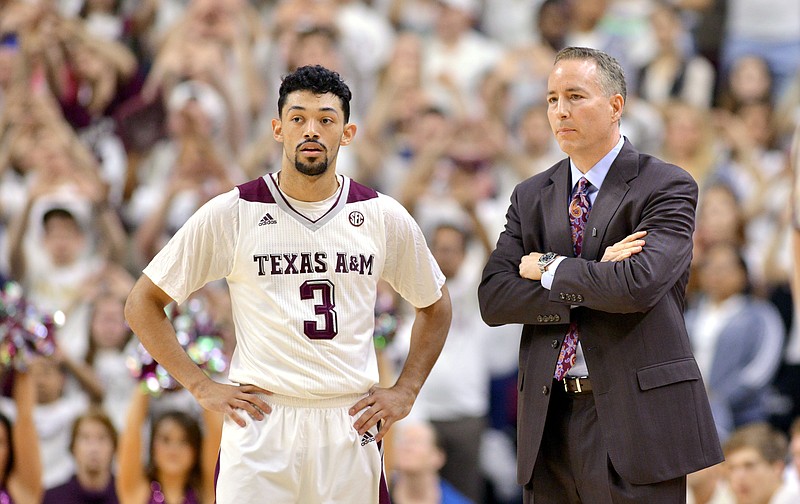 Texas A&M guard Alex Robinson (3) stands with Aggie coach Billy Kennedy during a free throw attempt in the first half of an NCAA college basketball game against Vanderbilt, Saturday, Jan. 31, 2015, at Reed Arena in College Station, Texas. Texas A&M won 69-58.