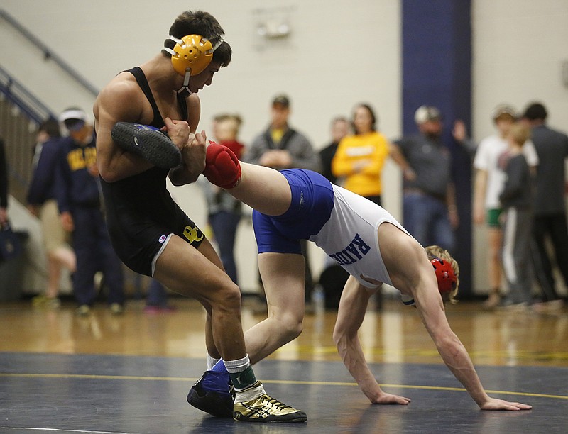 Bradley Central wrestler Toribio Navarro, left, grapples with Cleveland wrestler Tristian Blansit during their bout at the Region 4-AAA wrestling tournament finals Saturday, Feb. 8, 2014, at Walker Valley High School in Cleveland, Tenn.