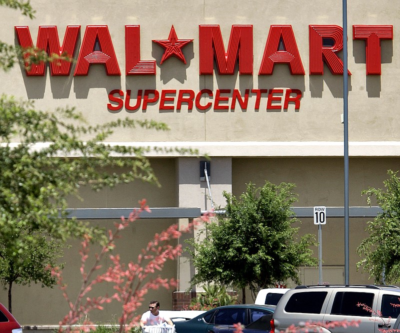 A shopper leaves a Wal-Mart Supercenter in Gilbert, Ariz., in this 2008 file photo.