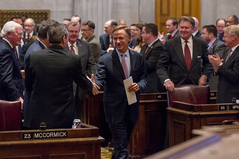 Republican Gov. Bill Haslam is greeted by lawmakers as he enters the House chamber in Nashville, Tenn., on Monday, Feb. 2, 2015. Haslam spoke to a joint assembly of the General Assembly to promote his Insure Tennessee proposal to extend health coverage to 280,000 low-income residents.