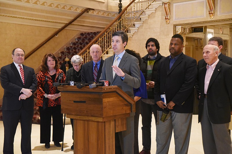 Mayor Andy Berke, center, speaks about the future of the Tivoli and the Memorial Auditorium Thursday morning during a press conference at the Tivoli.