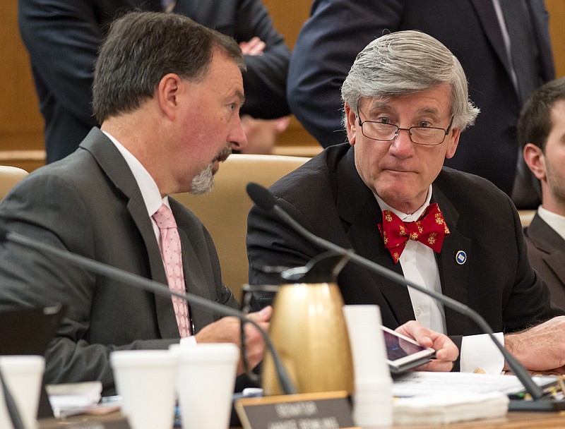 State Sens. Todd Gardenhire, right, R-Chattanooga, and Mike Bell, R-Riceville, confer during a Senate Health Committee meeting in Nashville in this photo taken Feb. 4, 2015. Gardenhire and Bell, who are both covered under the state-subsidized health plan, voted against Gov. Bill Haslam's proposal to extend insurance to 280,000 low-income Tennesseans. 