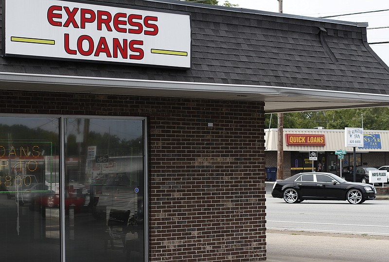 A motorist passes numerous loan service businesses off of Ringgold Road in East Ridge on in this file photo. Chattanooga has a high number of payday lenders. 