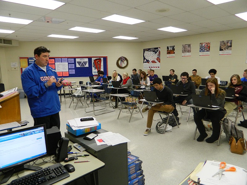 Adam Renshaw interacts with his students through traditional face-to-face communication and digital media in a United States Government class at Cleveland High School. Laptops, smartphones and other handheld devices became a prominent part of the school's social studies classes this year.
