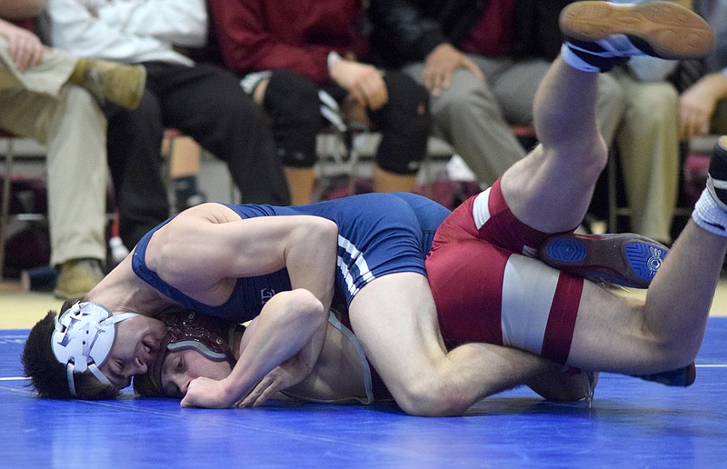 McCallie's Brock Herring controls Montgomery Bell Academy's Jed Griffin in the 132-pound matchon Friday, Jan. 6, 2015. 