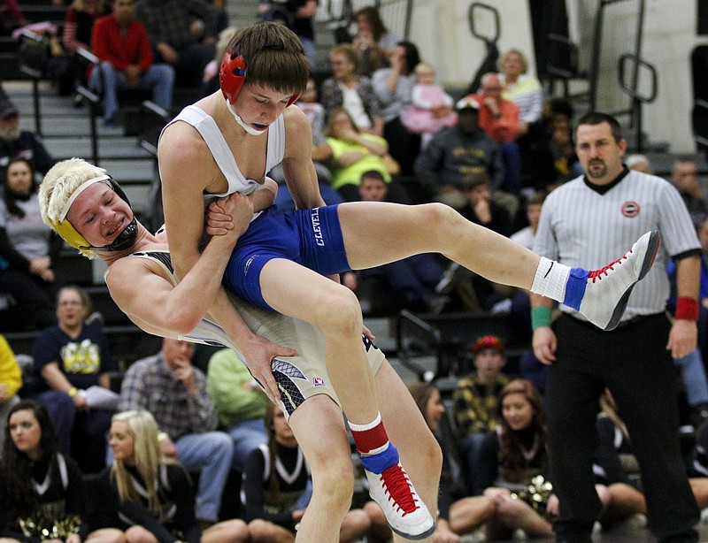 Bradley Central's TJ Hicks, left, wrestles Cleveland's Cody Matthews in their region 4-AAA wrestling tournament bout Saturday, Feb. 7, 2015, at Bradley Central High School in Cleveland, Tenn.