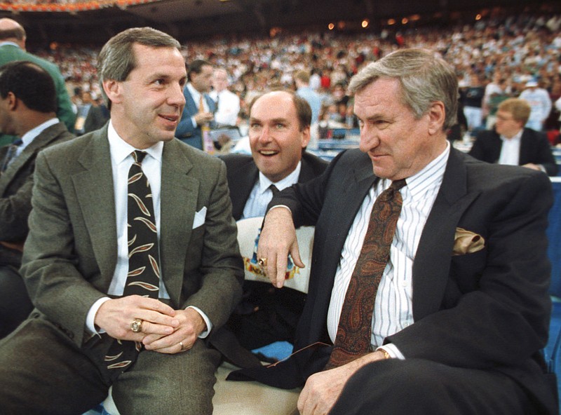 Kansas coach Roy Williams, left, and North Carolina coach Dean Smith talk before the start of their game in Indianapolis, Ind., in this 30, 1991 file photo.