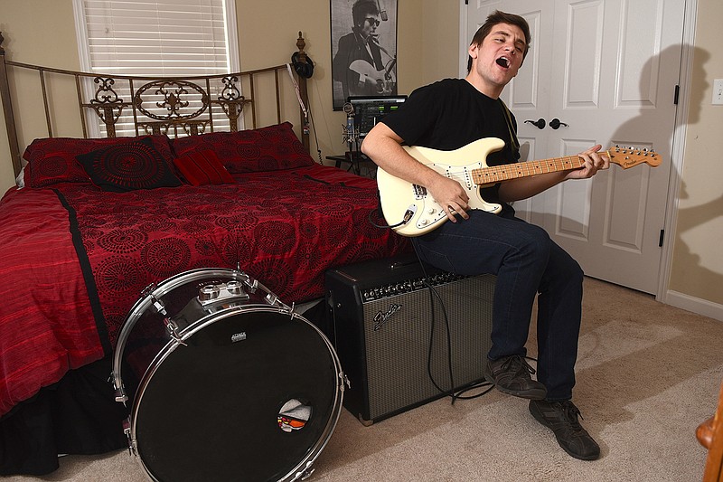 Nick Lutsko plays guitar in the bedroom of his Hixson home, where he recorded his second album, "Etc." He played the majority of the instruments, which included keyboards, bass and guitar but also hand claps, table tops, pots, pans and anything else he had lying around.