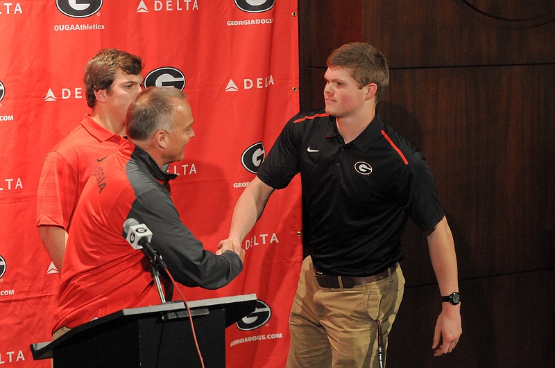 Tight end Jackson Harris, the only offensive early enrollee at Georgia this winter, receives a handshake from coach Mark Richt on National Signing Day.