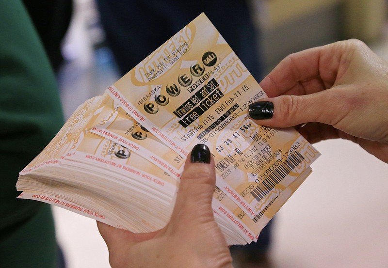 A lottery representative holds Powerball tickets in this file photo.