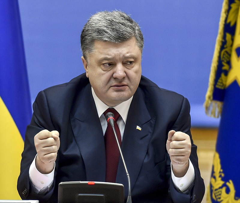 
              Ukrainian President Petro Poroshenko speaks during a cabinet meeting in Kiev, Ukraine, Wednesday, Feb. 11, 2015. On Wednesday French President Francois Hollande and German Chancellor Angela Merkel will go to the Belarusian capital of Minsk for the crucial talks on conflict in Ukraine's east with the presidents of Russia and Ukraine. (AP Photo/Mykola Lazarenko, Pool)
            