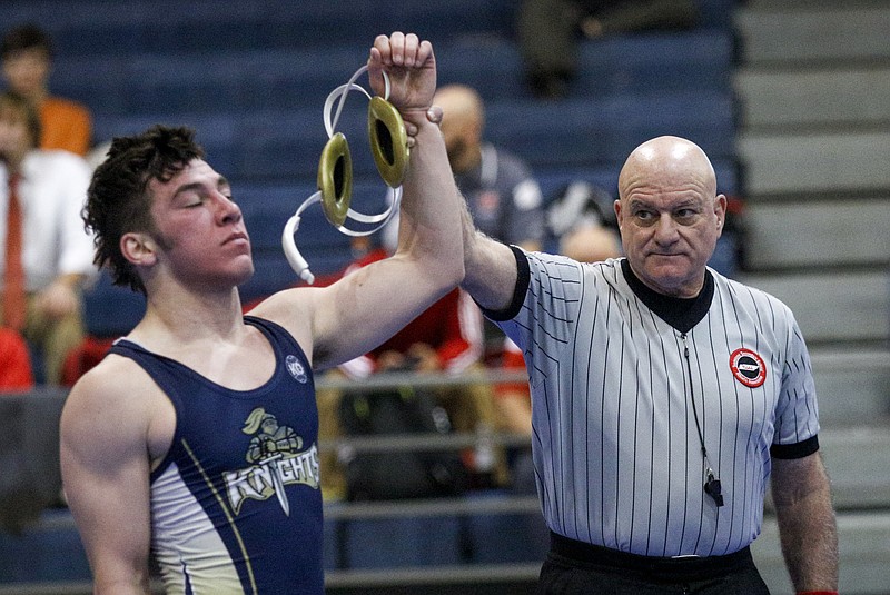 Wrestling referee Donnie Elsea, right, raises the hand of of Pope John Paul's Jacob Telli after Telli won his bout against Franklin Road Academy's Will Tansil in this Feb. 7, 2015, photo.