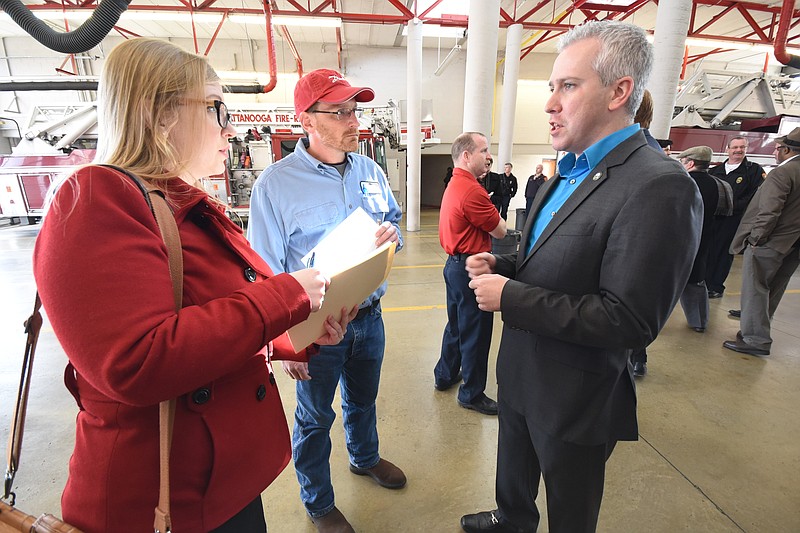 Chattanooga City Councilman Chris Anderson, right, talks with SEIU representatives Kate Sheets, left, and Steve Porter Thursday, Feb 12, 2015, before introducing a resolution against a senate bill designed to nullify municipal agreements with unions.