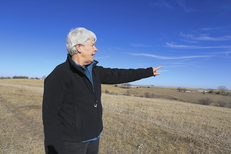 
              FILE- In this Jan. 16, 2015 file photo, Susan Dunavan, who opposes the Keystone XL pipeline, points to the planned route of the pipeline which will run through on her property, in York, Neb. TransCanada is temporarily suspending efforts to seize Nebraska land for the Keystone Pipeline XL amid a legal challenge. On Thursday, Feb. 12, 2015, a Holt County District judge issued a temporary injunction, keeping TransCanada from invoking eminent domain along the proposed Keystone Pipeline route in northern Nebraska. TransCanada agreed to the order, hoping to get an accelerated trial schedule. (AP Photo/Nati Harnik, file)
            