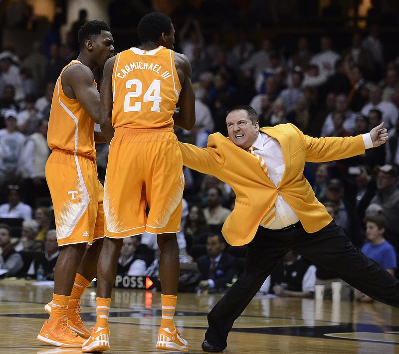 Tennessee head coach Donnie Tyndall pulls forward Armani Moore, left, and Willie Carmichael III (24) off the court during their game on Feb. 11, 2015, in Nashville. Tennessee won 76-73. 