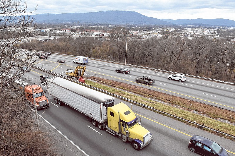 Trucks roll east on I-24 near Missionary Ridge, above, and on I-24 near Moccasin Bend, below left. Chattanooga is tops in the nation in volume of freight passing through by truck.