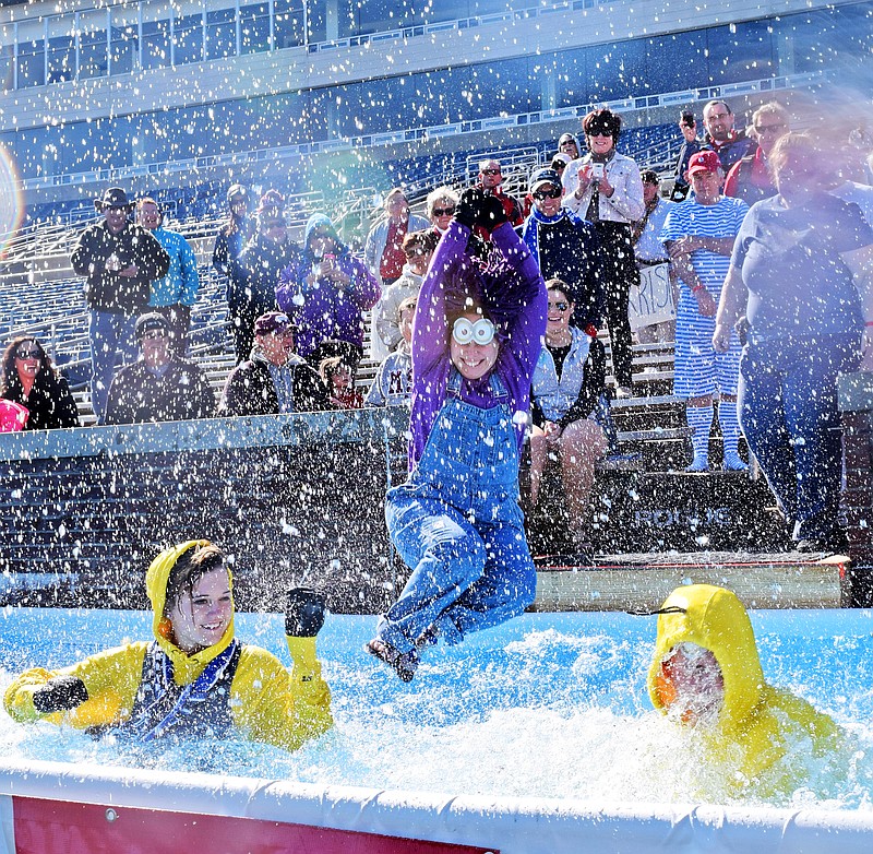 Chattanooga State Community College EMS program instructor Patrice Schermerhorn, center, is the last of her team, the "Super EMTS to the Rescue" to hit the water.  The Chattanooga Polar Plunge to benefit Special Olympics Tennessee was held at Finley Stadium.  The event raised $20,000 to support the program.