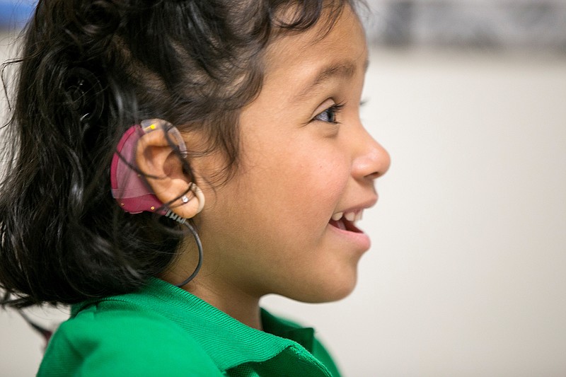 
              In this photo taken Feb. 11, 2015, Angelica Lopez, 3, smiles during a therapy session at the University of Southern California in Los Angeles. Angelica was born deaf and received an auditory brainstem implant to allow her to hear some sounds in a research study at USC. U.S. researchers are implanting a device on the brain stems of a small number of deaf children to see if it will help them learn to hear. The studies are aimed at children who don’t have working hearing nerves and thus don’t qualify for a more common technology, cochlear implants. The implants stimulate brain cells that those nerves normally target. (AP Photo/Damian Dovarganes)
            
