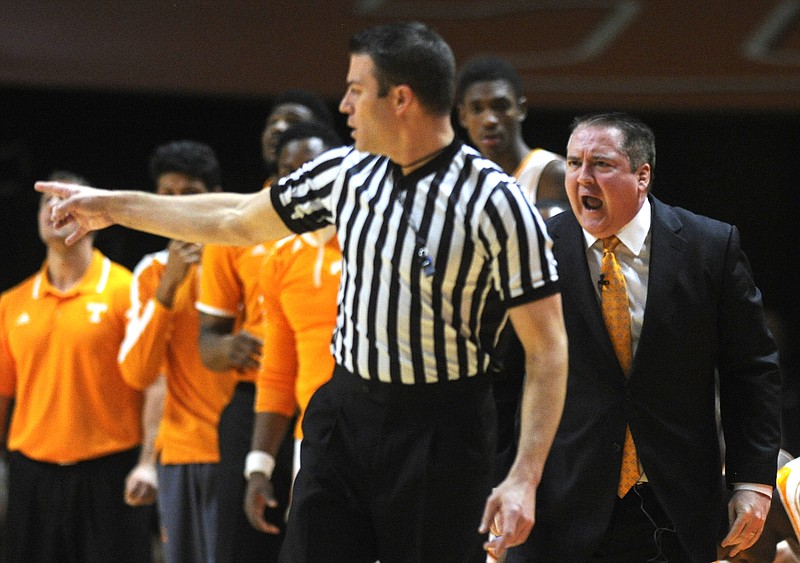 Tennessee head coach Donnie Tyndall, right, shouts at a referee on the sideline during the second half of an NCAA college basketball game against LSU in Knoxville on Feb. 14, 2015. LSU won 73-55. 