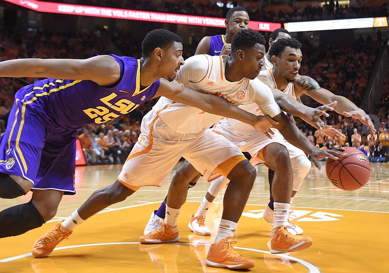LSU forward Jordan Mickey (25), Tennessee guard Armani Moore, center, and Tennessee guard Derek Reese, right, struggle for the ball during their game in Knoxville on Saturday, Feb. 14, 2015. LSU won 73-55. 