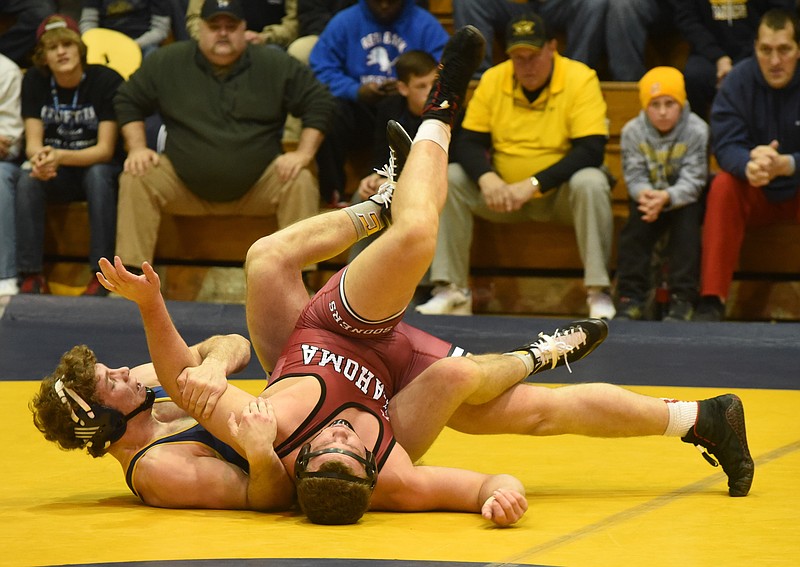 University of Tennessee at Chattanooga 285-pound-class wrestler Jared Johnson, left, controls Ross Larson of Oklahoma on the way to a 12-11 win in the final match of the day as the UTC team comes from behind to defeat Oklahoma by a team score of 19-16 on Sunday, Feb. 15, 2015, in Chattanooga.