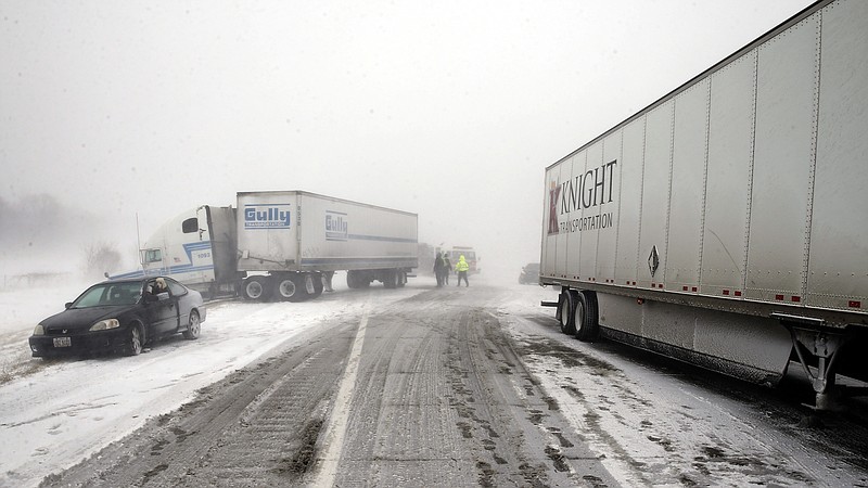 A multi-vehicle accident in near white out conditions, blocks west bound I-70, Saturday, Feb. 14, 2015 west of Columbus, Ohio. Heavy blowing snow is making travel difficult across Ohio and has caused quite a few accidents on the interstates. (AP Photo/Alex Brandon)