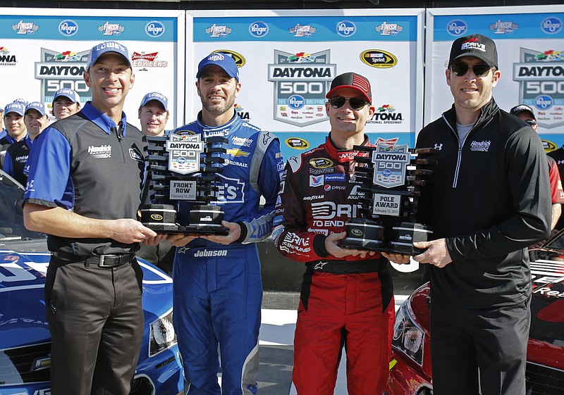 Pole winner Jeff Gordon, second from right, and Jimmie Johnson, second from left, pose for photos with their crew chiefs, Chad Knaus, left, and Alan Gustafson, after qualifying for the top two positions for the Daytona 500 NASCAR Sprint Cup Series auto race at Daytona International Speedway on Sunday, Feb. 15, 2015, in Daytona Beach, Fla. 
