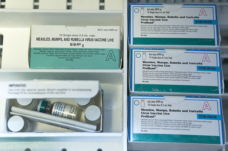 
              FILE - This Thursday, Jan. 29, 2015, file photo, shows boxes of the measles, mumps and rubella virus vaccine (MMR) and measles, mumps, rubella and varicella vaccine inside a freezer at a doctor's office in Northridge, Calif. While much of the attention in the ongoing measles outbreak has focused on student vaccination requirements and exemptions, less attention has been paid to another group in the nation’s classrooms: Teachers and staff members, who by and large are not required to be vaccinated. (AP Photo/Damian Dovarganes, File)
            